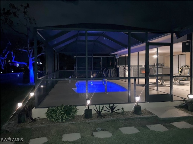 view of swimming pool with a lanai and a patio