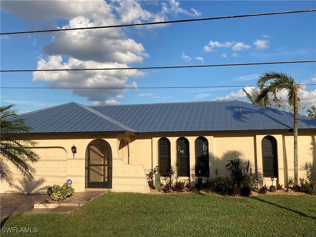 view of front facade with a front yard and a garage