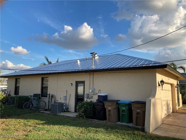 back of house featuring cooling unit and a lawn