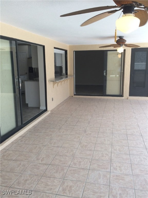 view of patio featuring ceiling fan