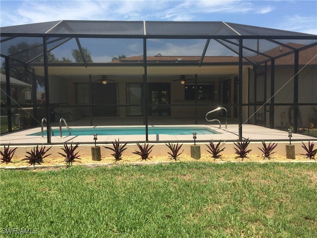 view of swimming pool with a lawn, ceiling fan, and a lanai