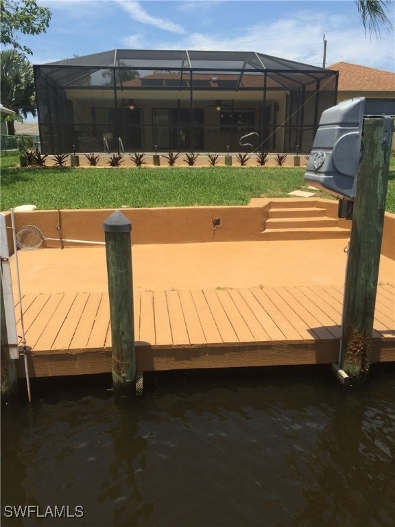 wooden deck featuring a dock and a lanai