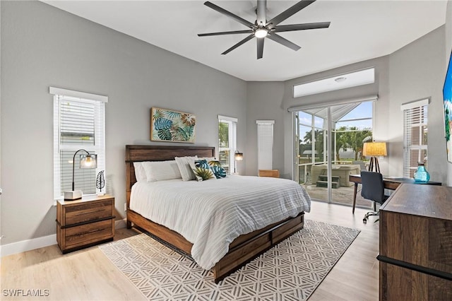 bedroom with light wood-type flooring, access to outside, and ceiling fan