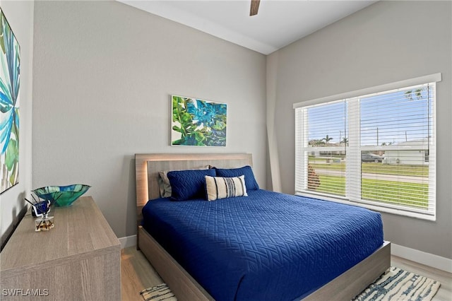 bedroom with ceiling fan and light wood-type flooring