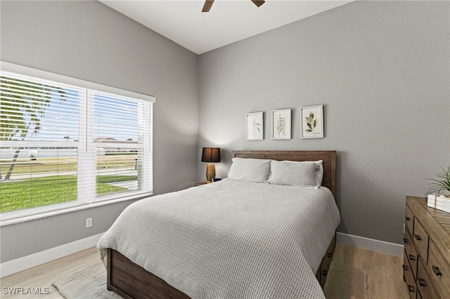 bedroom with ceiling fan and light wood-type flooring