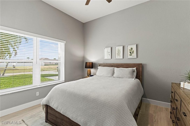 bedroom with ceiling fan and light hardwood / wood-style flooring