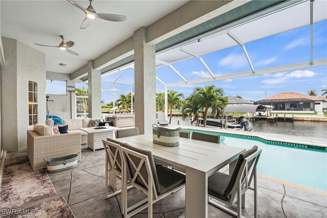 view of patio with outdoor lounge area, ceiling fan, a water view, and glass enclosure