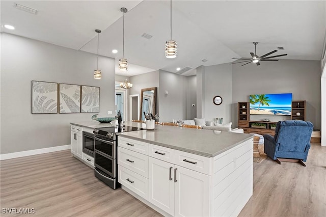 kitchen featuring white cabinetry, hanging light fixtures, double oven range, ceiling fan, and light hardwood / wood-style floors