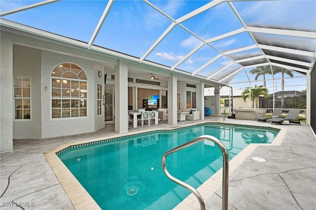 view of pool with a lanai, a patio, and a jacuzzi