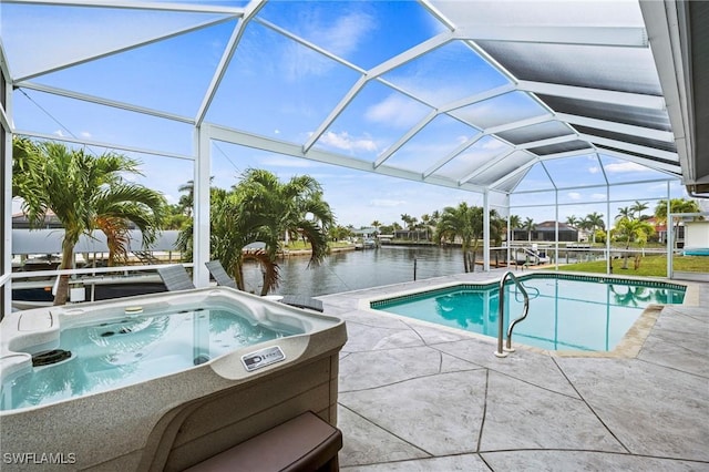 view of swimming pool featuring an outdoor hot tub, a patio, glass enclosure, and a water view