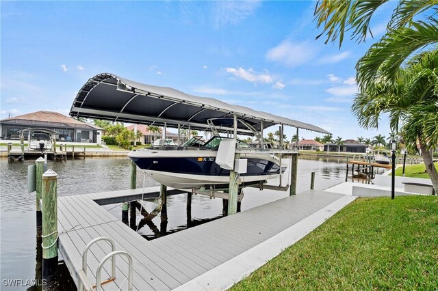 dock area featuring a lawn and a water view