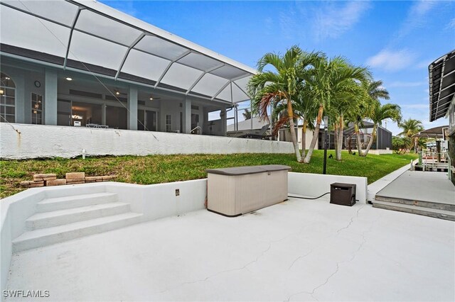 view of patio with glass enclosure