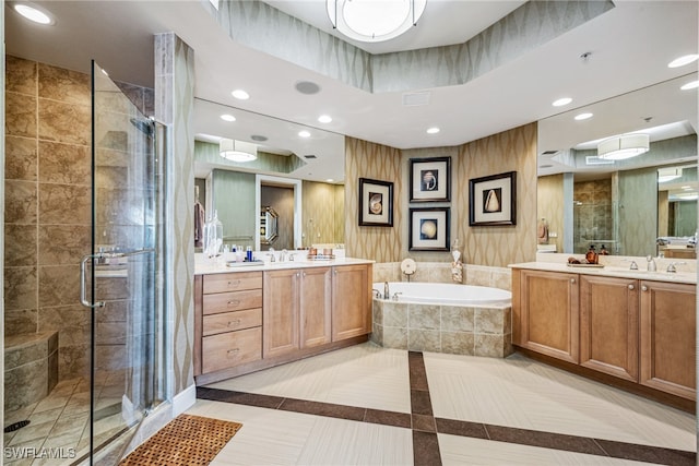 bathroom featuring vanity, tile patterned flooring, and plus walk in shower