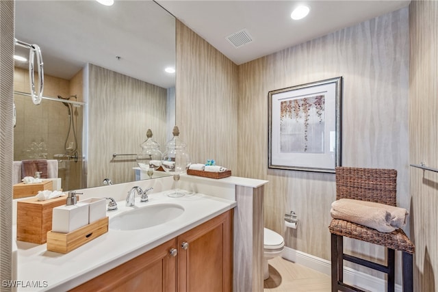 bathroom with vanity, an enclosed shower, and toilet