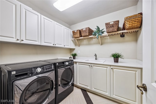 washroom with washer and clothes dryer, sink, and cabinets