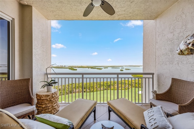 balcony with a water view and ceiling fan