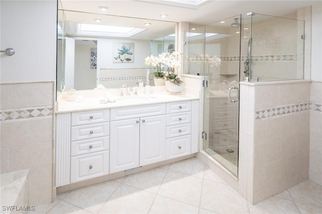 bathroom featuring tile patterned floors, vanity, and an enclosed shower