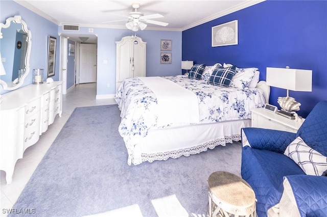 carpeted bedroom featuring ceiling fan and ornamental molding