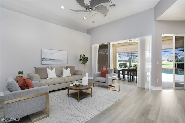 living room featuring ceiling fan and light wood-type flooring