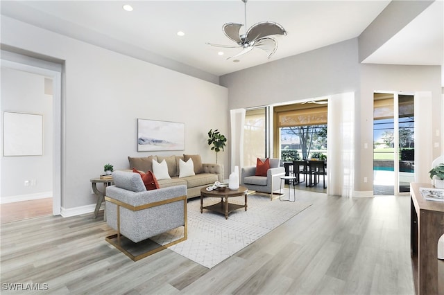 living room with ceiling fan and light hardwood / wood-style floors