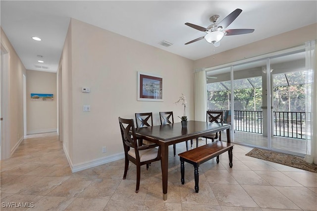 tiled dining room featuring ceiling fan