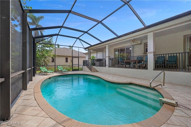 view of pool featuring ceiling fan, a lanai, and a patio