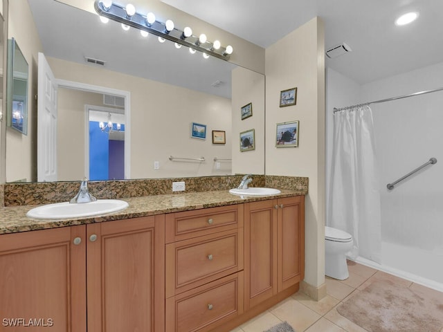 bathroom with tile patterned flooring, vanity, toilet, and curtained shower