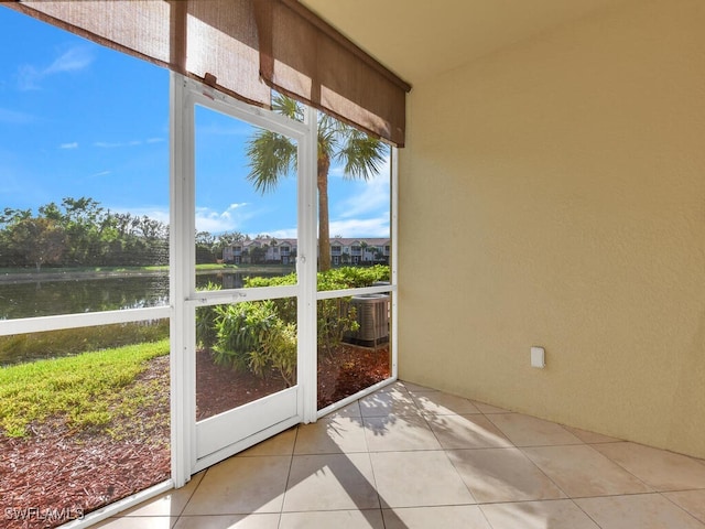 unfurnished sunroom with a water view