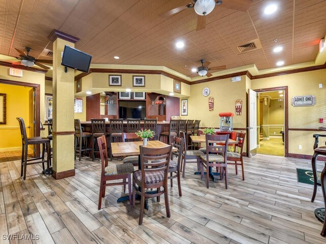 dining area featuring ceiling fan, light hardwood / wood-style floors, and ornamental molding