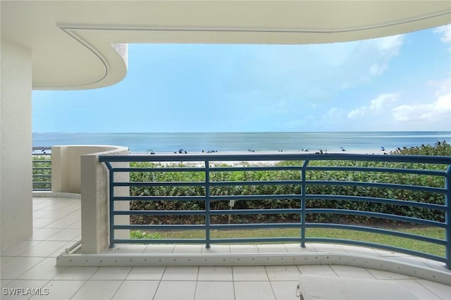 balcony featuring a water view and a view of the beach