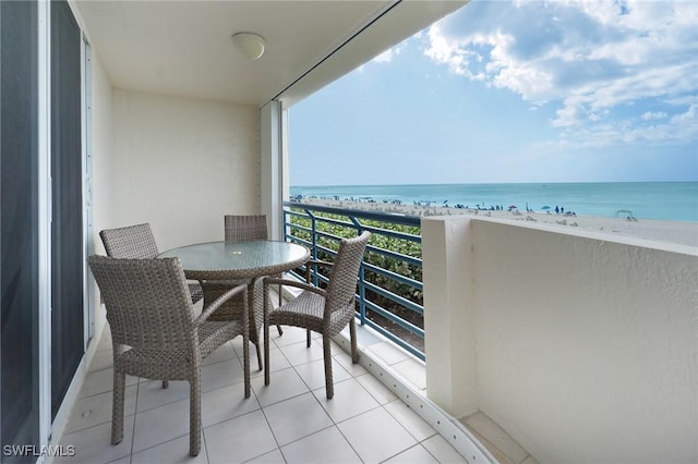 balcony featuring a water view and a beach view