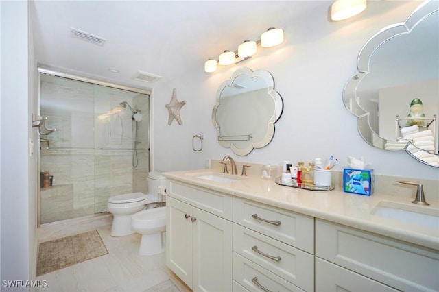 bathroom featuring vanity, a bidet, an enclosed shower, and toilet