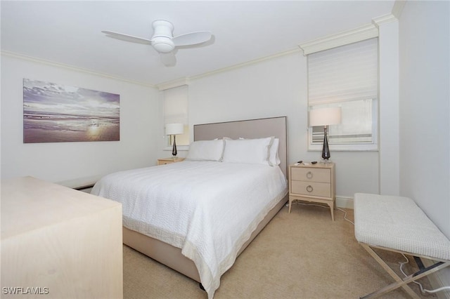 bedroom with ceiling fan, crown molding, and light carpet