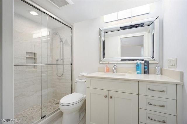 bathroom with vanity, an enclosed shower, and toilet