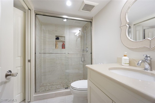 bathroom featuring vanity, toilet, and a shower with shower door