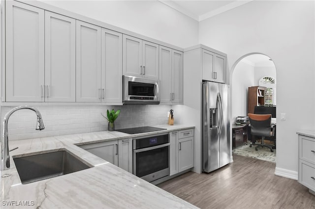 kitchen featuring sink, light stone countertops, appliances with stainless steel finishes, and gray cabinets