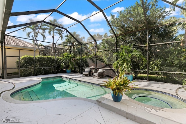 view of swimming pool with an in ground hot tub, a patio area, and glass enclosure