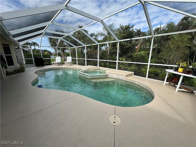 view of pool with a lanai, a patio area, and an in ground hot tub