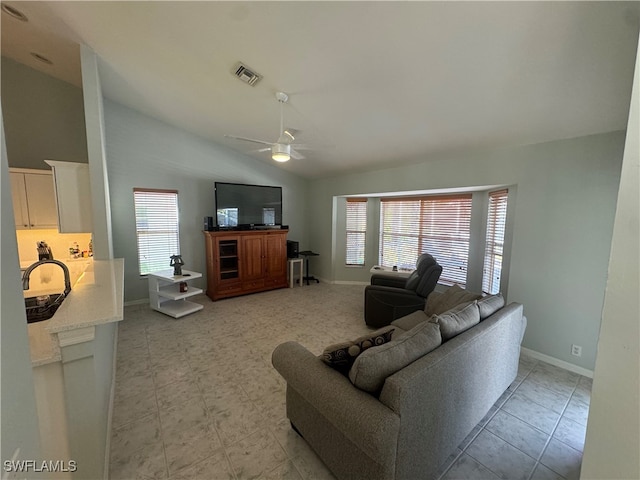 living room featuring ceiling fan and lofted ceiling