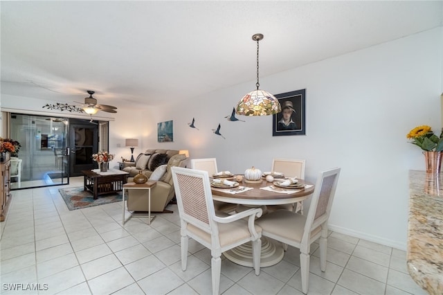 dining space with ceiling fan and light tile patterned floors