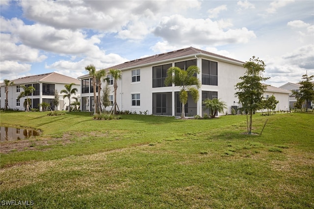 back of house featuring a yard