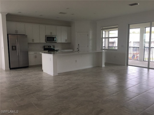 kitchen featuring white cabinets, a kitchen island with sink, and appliances with stainless steel finishes