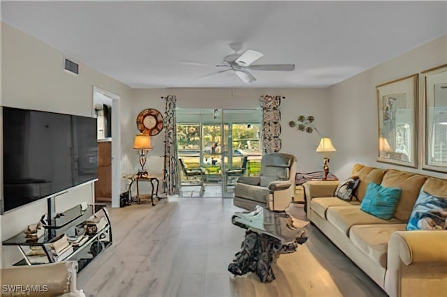 living room featuring ceiling fan and light wood-type flooring