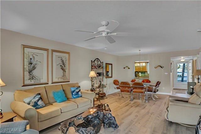 living room with ceiling fan and wood-type flooring