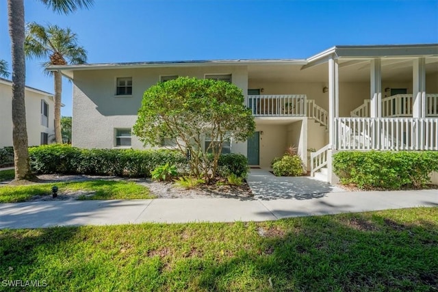 multi unit property with stairway and stucco siding