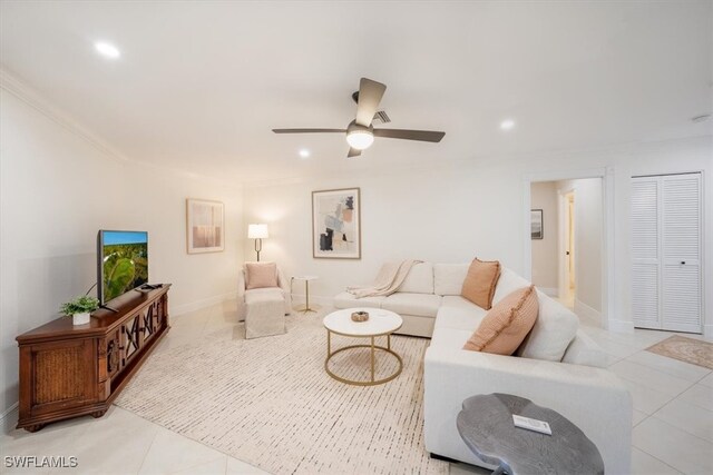 tiled living room featuring ceiling fan and crown molding