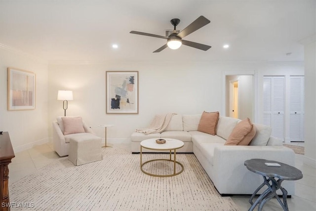 tiled living room with ceiling fan and ornamental molding