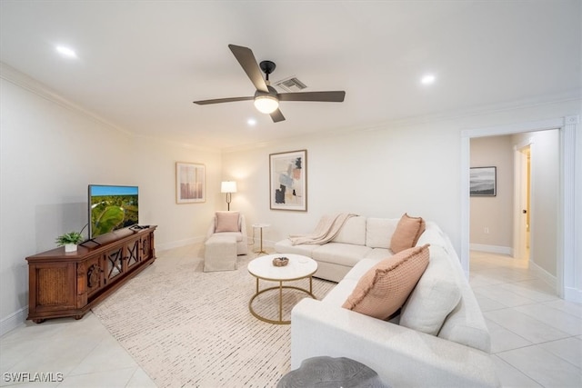 living area featuring ornamental molding, light tile patterned flooring, baseboards, and a ceiling fan