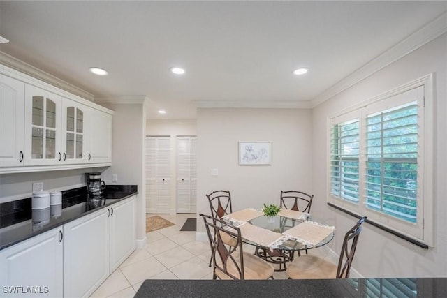 dining room with recessed lighting, baseboards, crown molding, and light tile patterned flooring