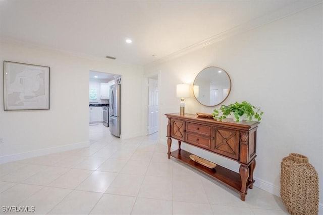 corridor with light tile patterned floors, ornamental molding, recessed lighting, and baseboards